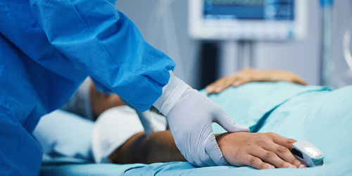 Critical care nurses rushing a patient on a hospital gurney.