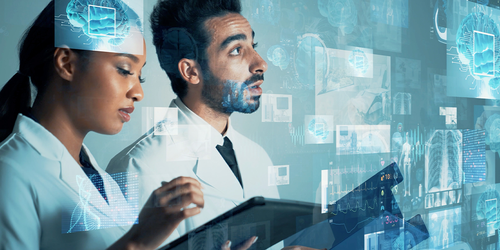 Health information technologists reviewing digital medical records and imaging data.