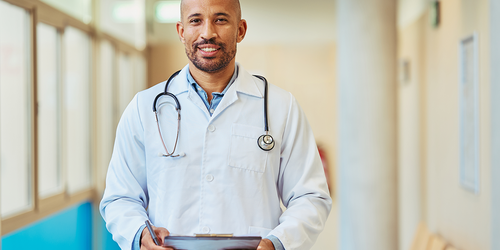 Healthcare leaders and physicians discussing patient care in a hospital.