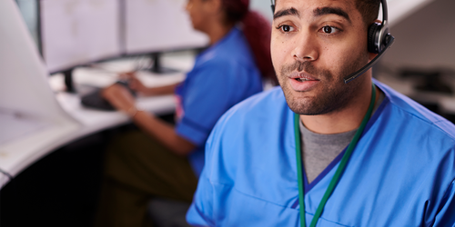 Healthcare call center staff assisting patients by phone and computer.