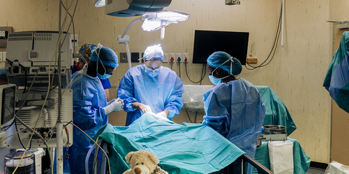 Pediatric surgical team operating in a child’s operating room.