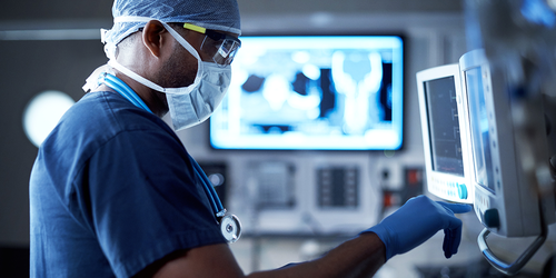 Surgeons performing an operation under bright surgical lights.