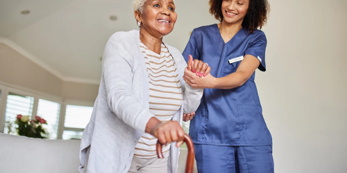 Caregiver assisting a senior woman with daily activities, providing home care and support.